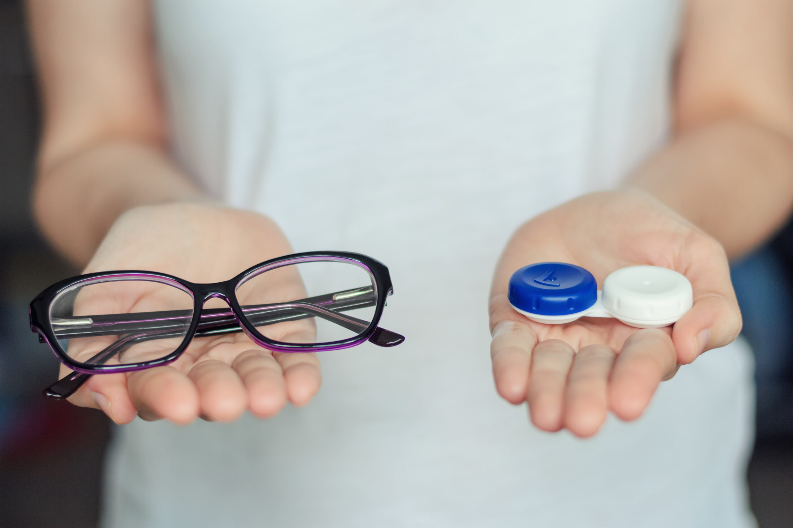 woman-hold-contact-lenses-and-glasses-in-hands-scaled.jpg