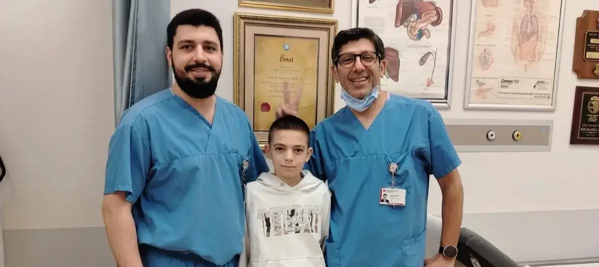 Emo, a 13-year-old boy with two doctors after successful transplant surgeries made possible by a fundraising campaign
